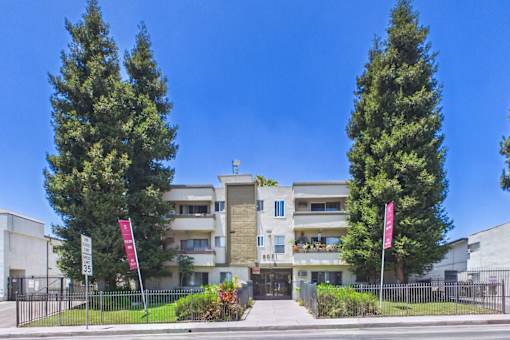 A modern building with a flag on the left and right side.