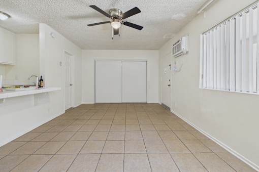 A room with a ceiling fan and a closed door.