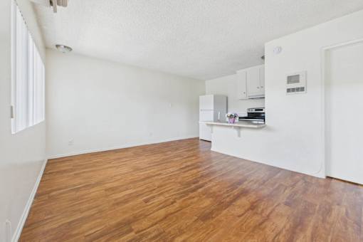 A room with wooden floors and white walls.