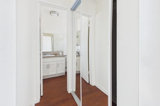 A bathroom with a mirror and sink.