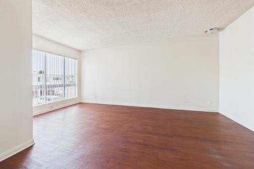A room with a wooden floor and a window.