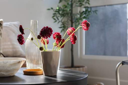 A table with a vase and a bowl on it at Skylar At Sunset Apartments, Los Angeles 90027