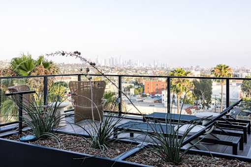 A balcony with a view of the city skyline at Skylar At Sunset Apartments, Los Angeles, California