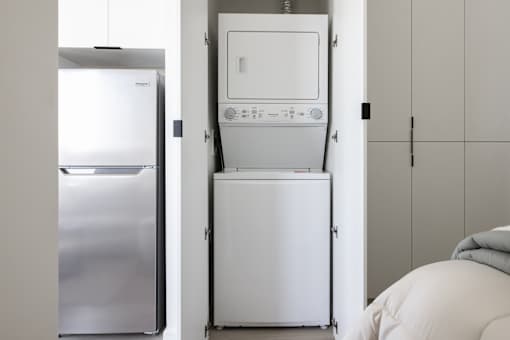 A white dishwasher is stacked on top of a white refrigerator at Skylar At Sunset Apartments, California, 90027