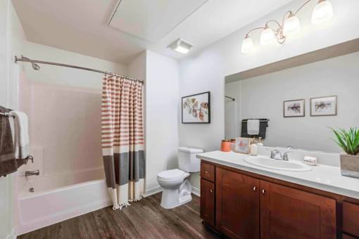 A bathroom with a toilet, sink, and shower.