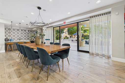 A dining room with a long table and chairs.