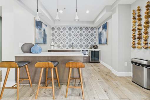 A kitchen with a bar area and a wall hanging.