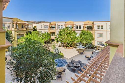 A courtyard with a fountain and seating area surrounded by buildings.
