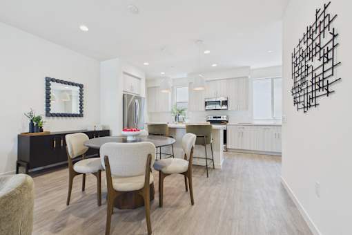 A modern dining room with a wooden table and chairs.