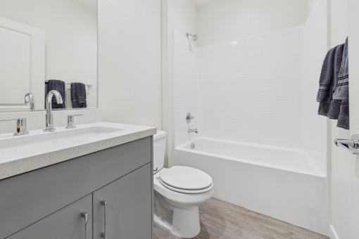 A white toilet sits next to a sink in a bathroom.