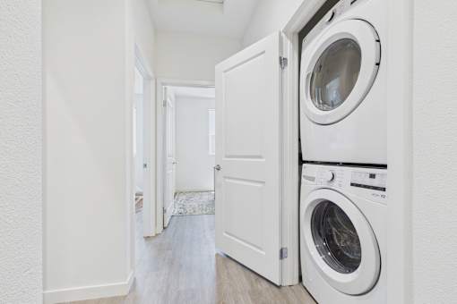 A white laundry room with a washer and dryer.