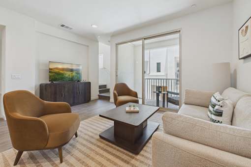A living room with a brown chair and a beige couch.