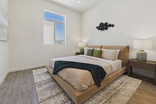 A bedroom with a large bed and a window.