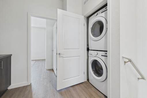 A white door is open to a laundry room.