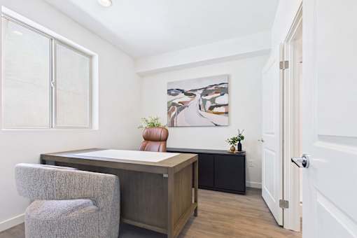 A room with a desk and a chair.