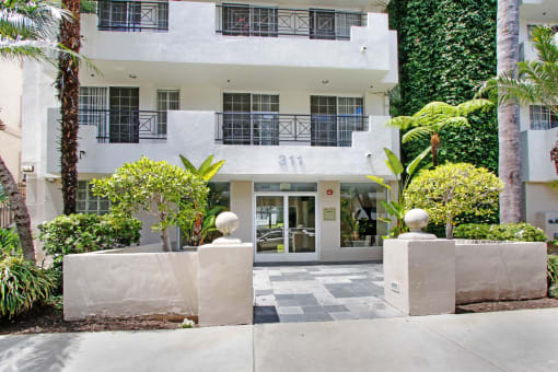 a white building with a green wall on the side of it