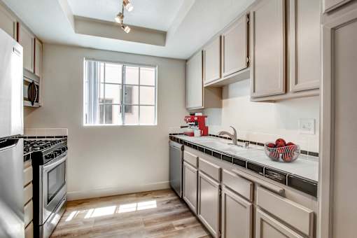 A kitchen with a stove top oven and a window.