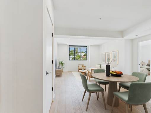 A dining room with a table and chairs.