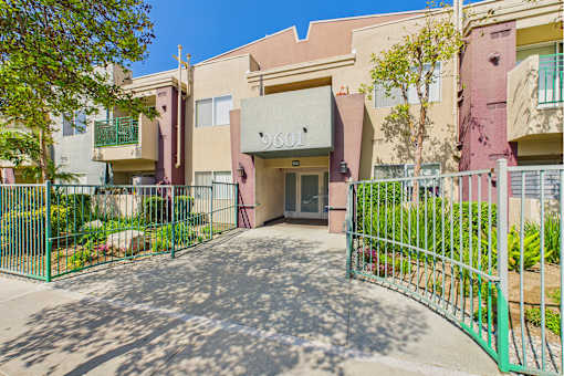 The entrance to a building with a green gate.