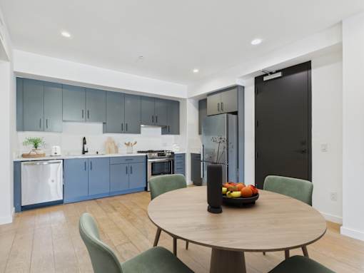A modern kitchen with a dining table and chairs.