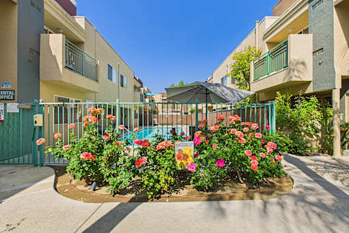 A flower bed in front of a building with a sign that says "Entertainment".