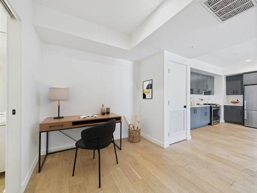 A room with a desk and chair in it.