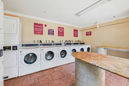 A row of washing machines in a public laundromat.