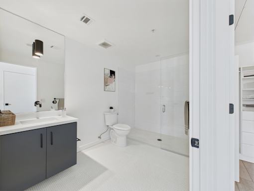 A bathroom with a white toilet and a white sink.