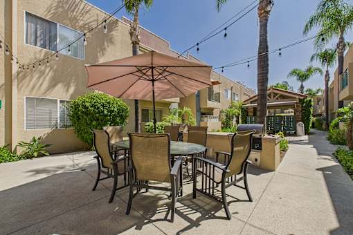 A patio with a table and chairs under a canopy.
