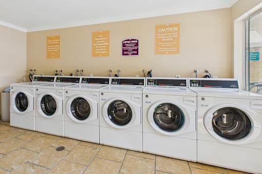 A row of washing machines in a public laundromat.