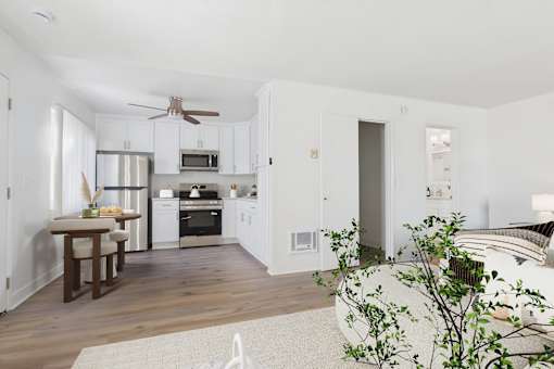 A kitchen with a dining table and chairs.