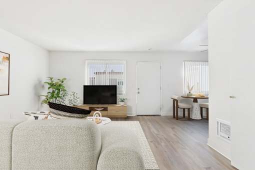 A living room with a grey sofa and a wooden coffee table.
