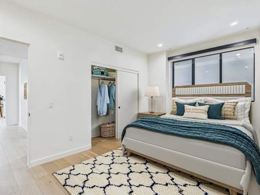 A bedroom with a large bed and a wardrobe.