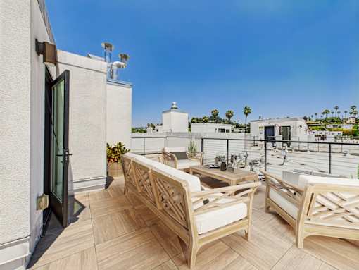 A patio with two chairs and a table.