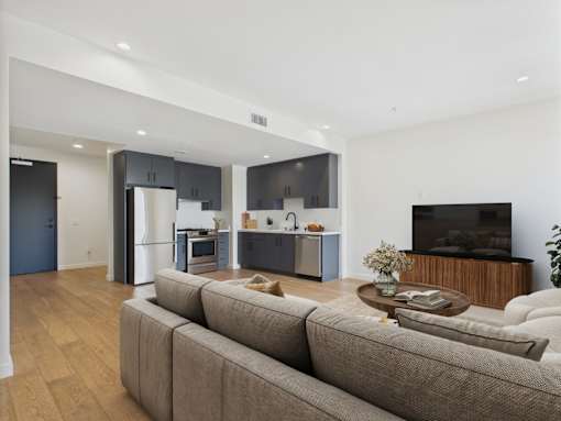 A modern living room with a grey sofa and a wooden coffee table.