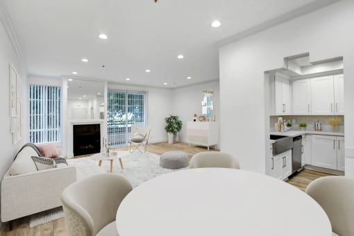 a living room with a round white table and a kitchen