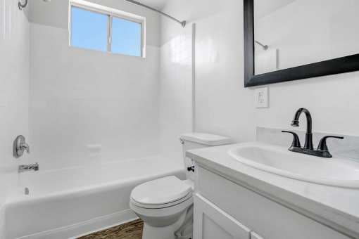 a bathroom with a sink toilet and a bath tub