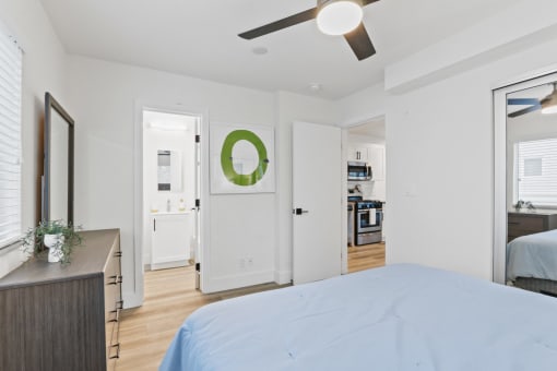 a bedroom with a large bed and a ceiling fan