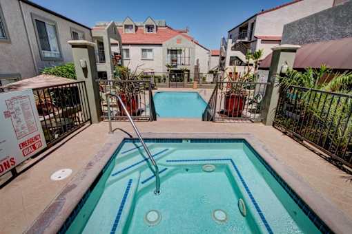 A small pool with a ladder in the middle of it.