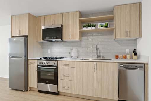 A modern kitchen with wooden cabinets and stainless steel appliances.