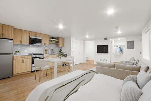 A modern kitchen with a dining table and a couch.