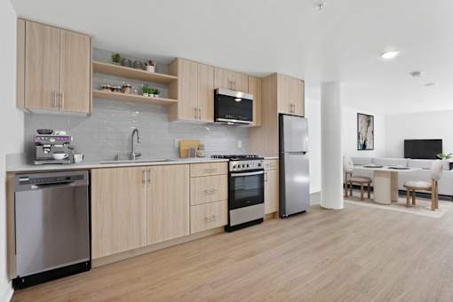 A modern kitchen with wooden cabinets and stainless steel appliances.