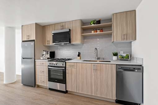 A modern kitchen with wooden cabinets and stainless steel appliances.