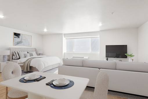 A modern living room with a white dining table and a white sofa.