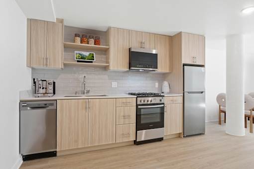 A kitchen with wooden cabinets and stainless steel appliances.