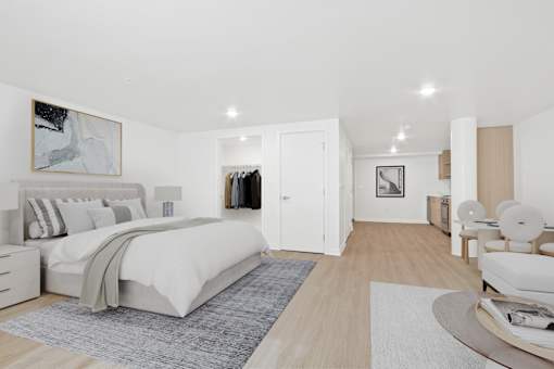 A bedroom with a large bed and a painting on the wall.