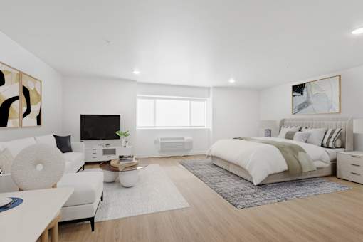 A modern bedroom with a large bed and a white sofa.