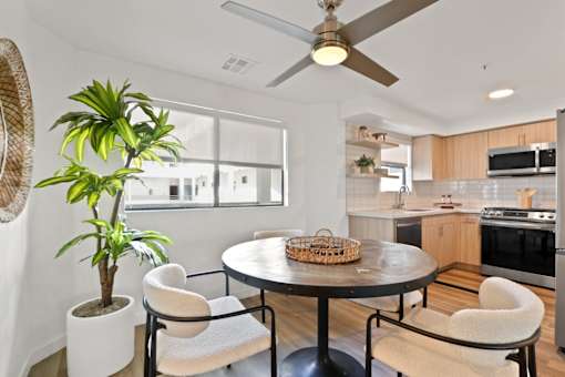 A modern kitchen with a round table and chairs.