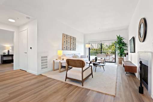 A living room with a white couch and a wooden coffee table.