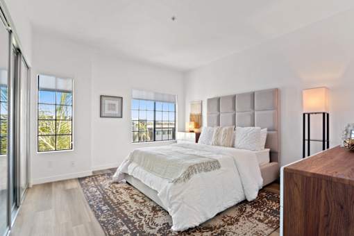 A bedroom with a large bed and a view of the outside.
